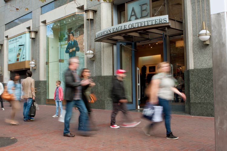 Motion Blur Of Shoppers Passing Storefront In San Francisco