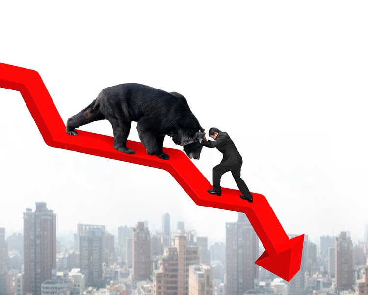 Businessman against bear on arrow downward trend line with citys