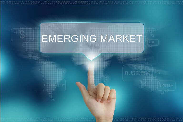 hand clicking on emerging market button