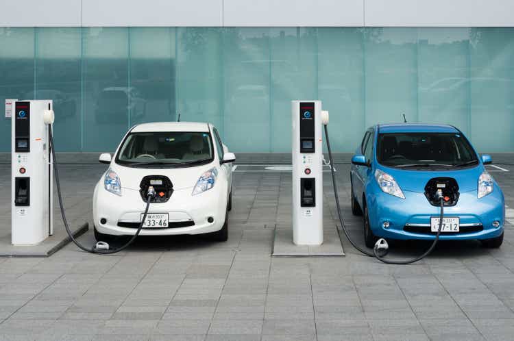 Electric cars being charged at charging stations