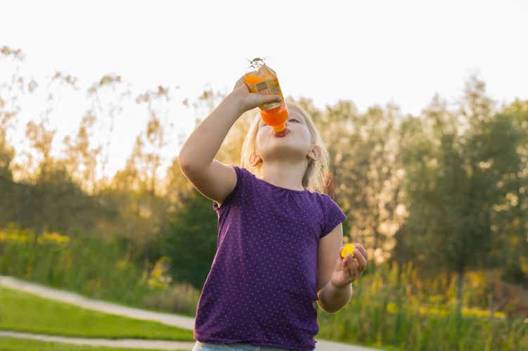 girl drinks juice from bottle