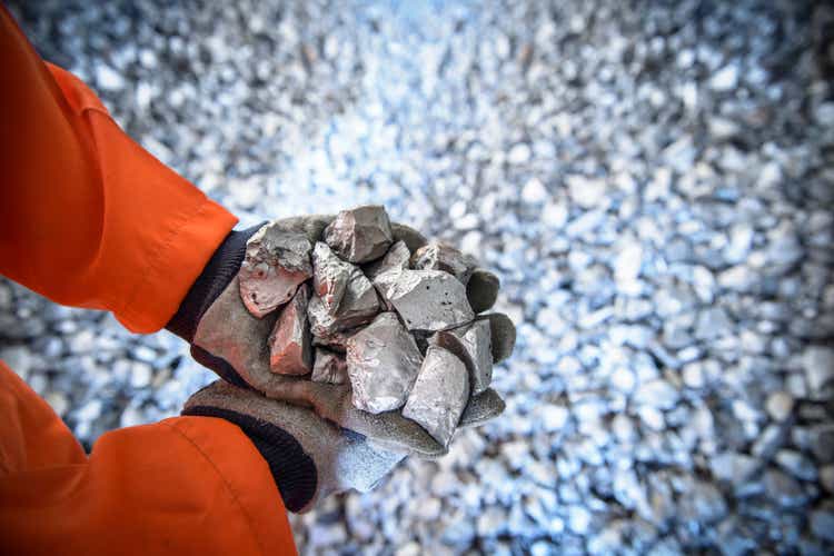 Close up of workers hands holding crushed titanium