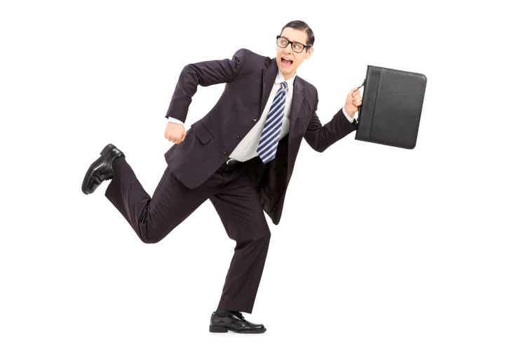 Scared male businessman running away from something