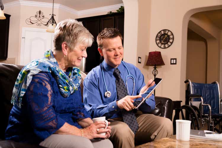 Healthcare: Concierge doctor visits senior woman at home.