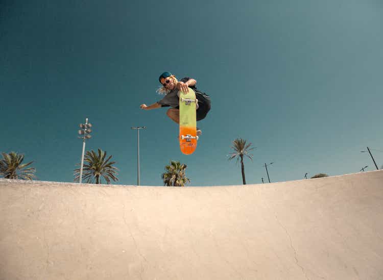 Young man jumping with skateboard