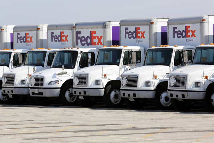 Fleet of FedEx delivery trucks in a parking lot