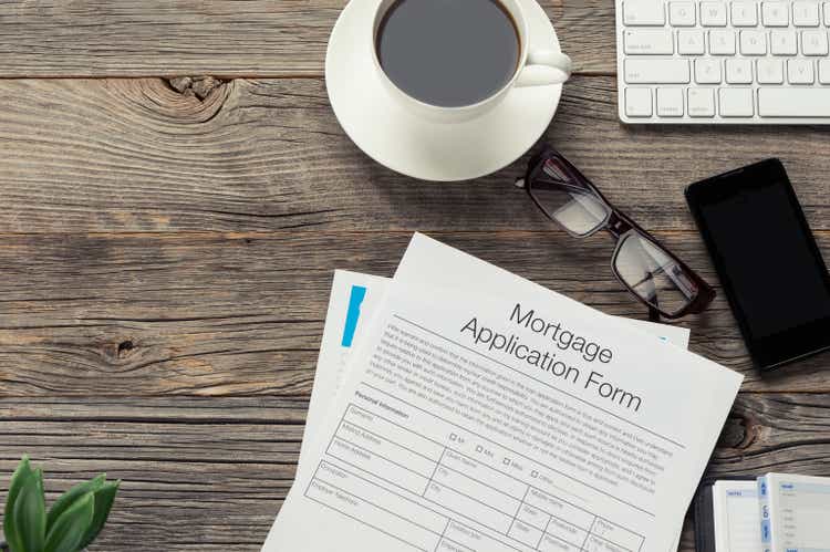 Mortgage application form on wooden table.