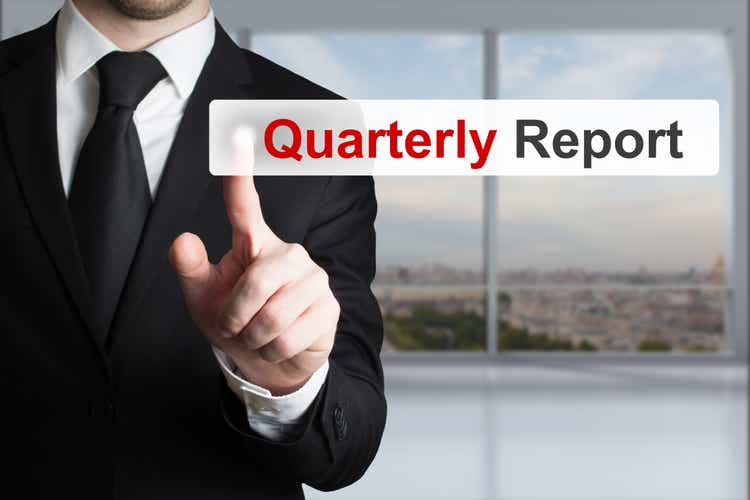 Businessman pressing button quarterly report