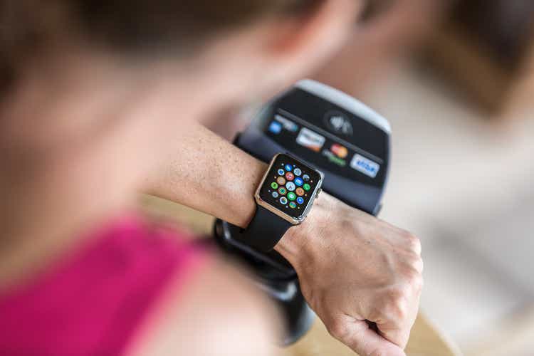 Woman Paying using Apple Watch and Electronic Reader