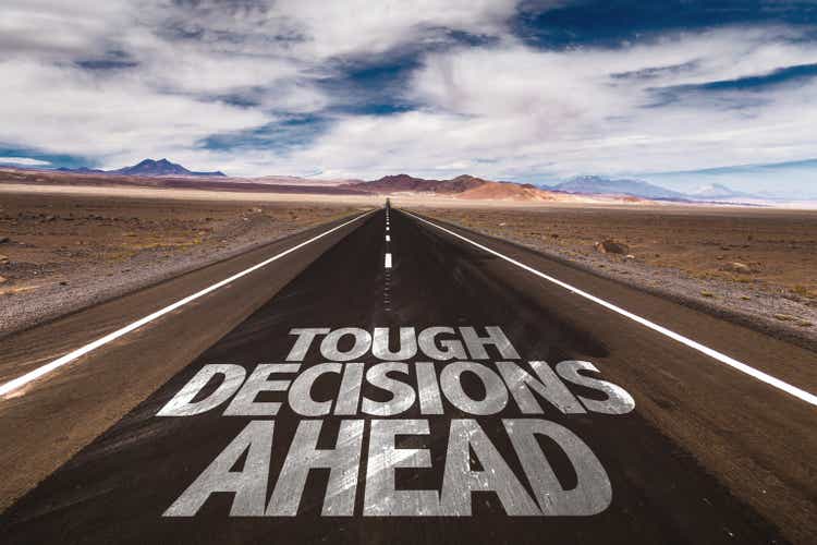 Tough Decisions Ahead written on desert road