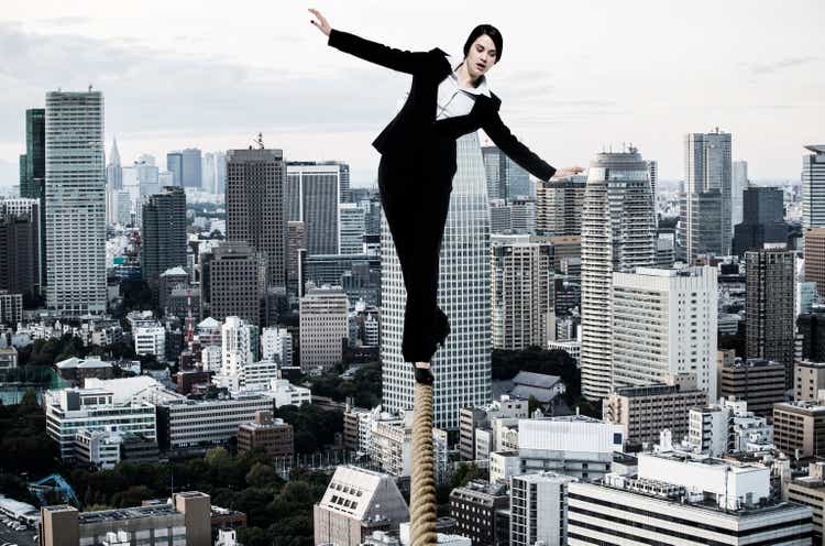 Businesswoman walking on tightrope