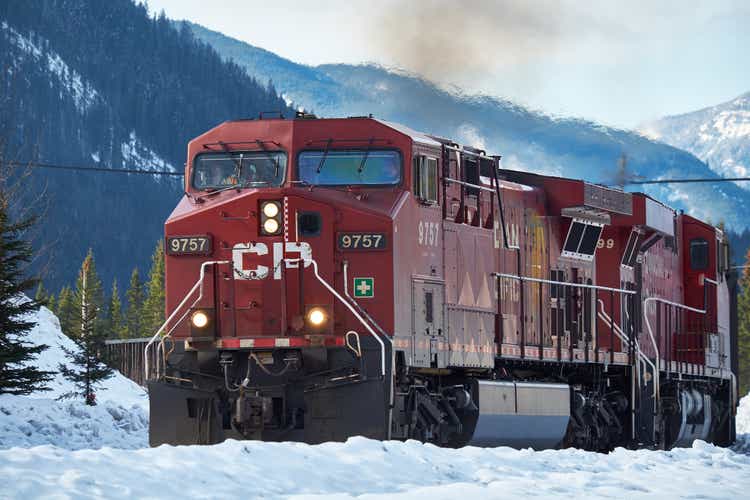 Canadian Pacific train with Canadian Rockies in the background in winter