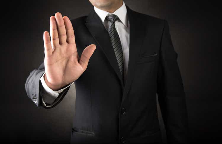 Businessman showing stop sign