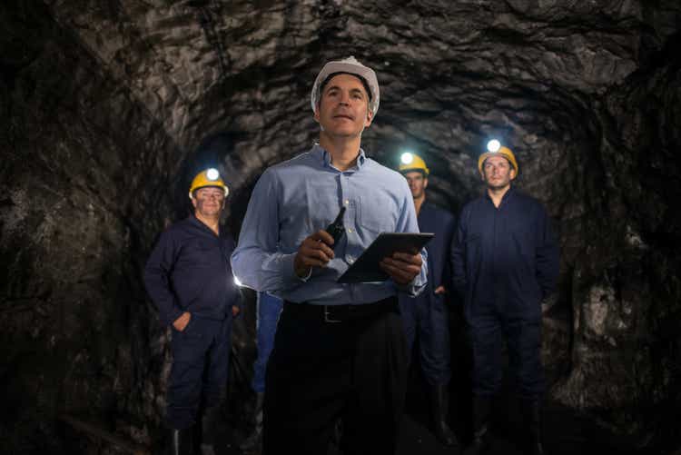 Engineer leading a group of miners