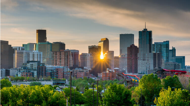 Sunrise peeks through the skyline of Denver