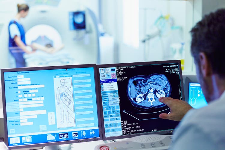 Doctor running CT scan from control room