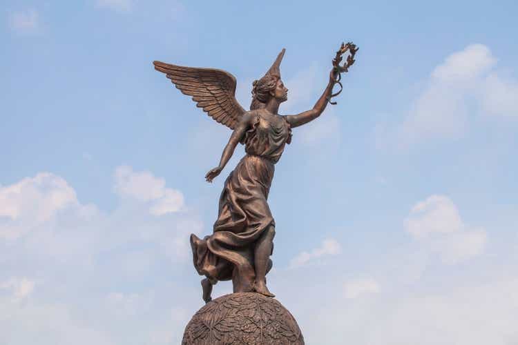 Goddess of victory Nike against the clouds and sky.