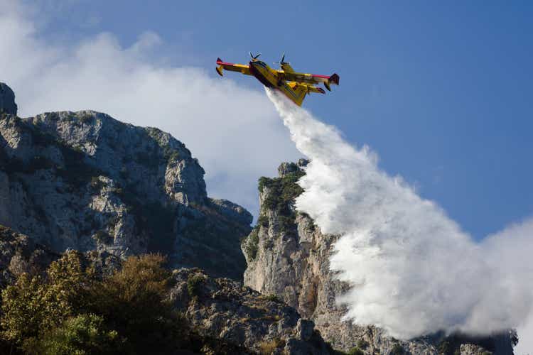 Yellow fire fighter aircraft drops all the water