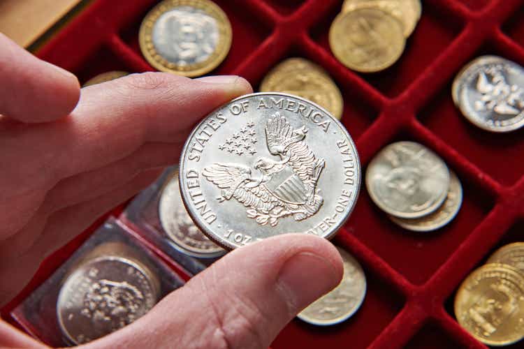 American dollar in hand of numismatist