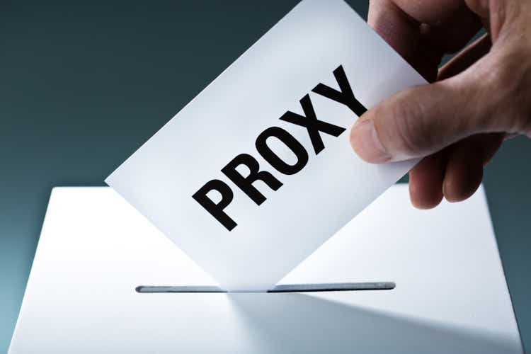 Proxy Voter Voting Ballot Over Ballot Box