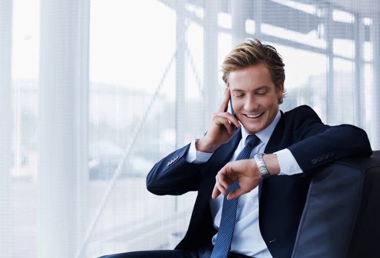 Businessman checking time in office