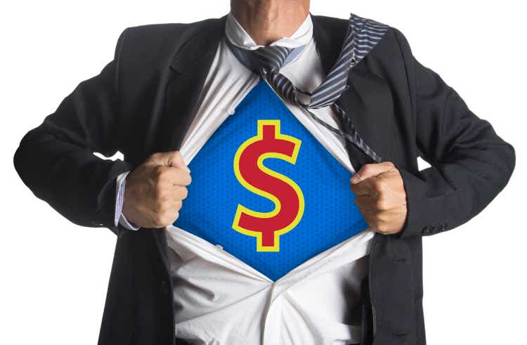 Businessman showing a superhero suit underneath dollar symbol