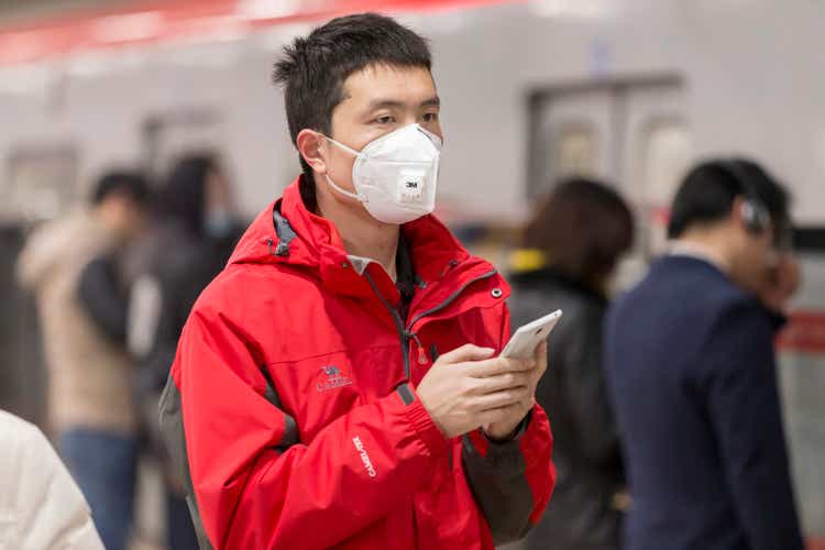 Boy wearing mouth mask with filter against air pollution, Beijing