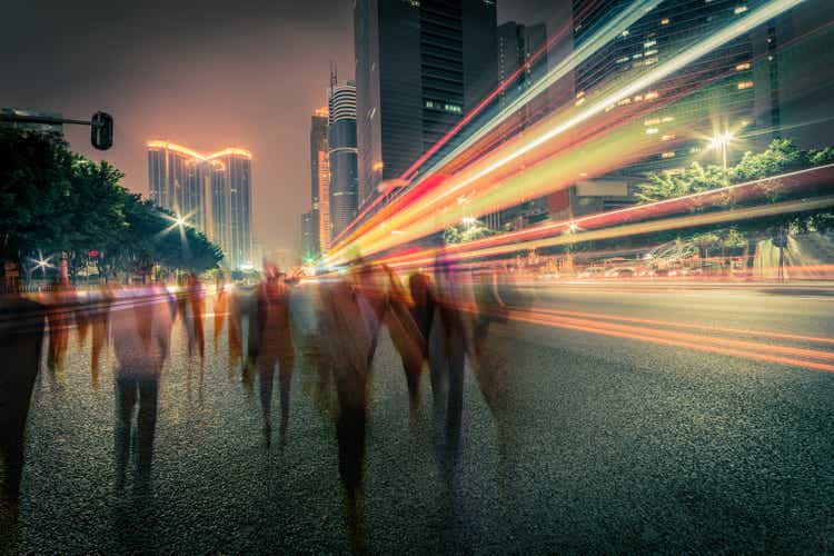 blur people and traffic on a street at night