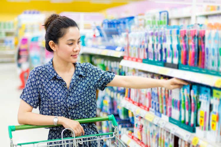 Asian woman buys a toothbrush