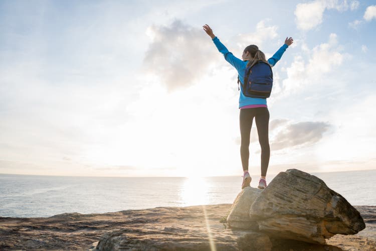 Happy hiker reaching the top