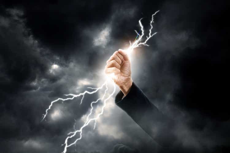 business woman hand clenching lightning flash