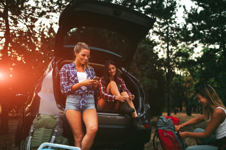 Young Women Preparing For Hike and Camping In Forest.