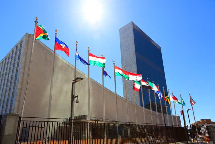 United Nations Headquarters with waving flags in New York, USA