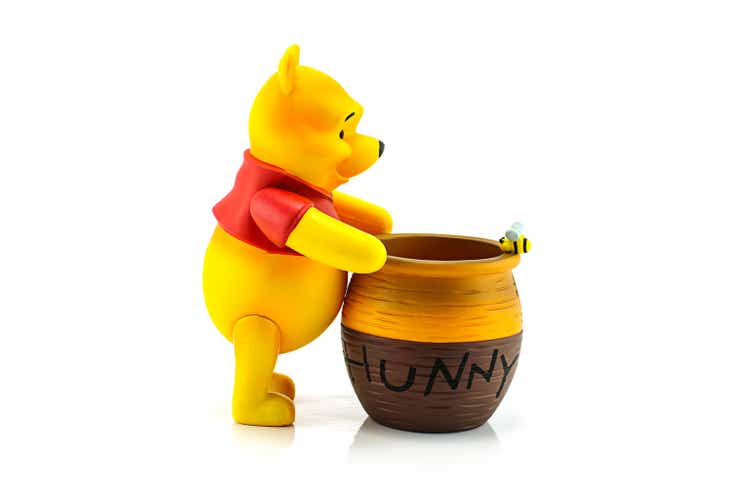 Figure of Winnie the Pooh and hunny pot.