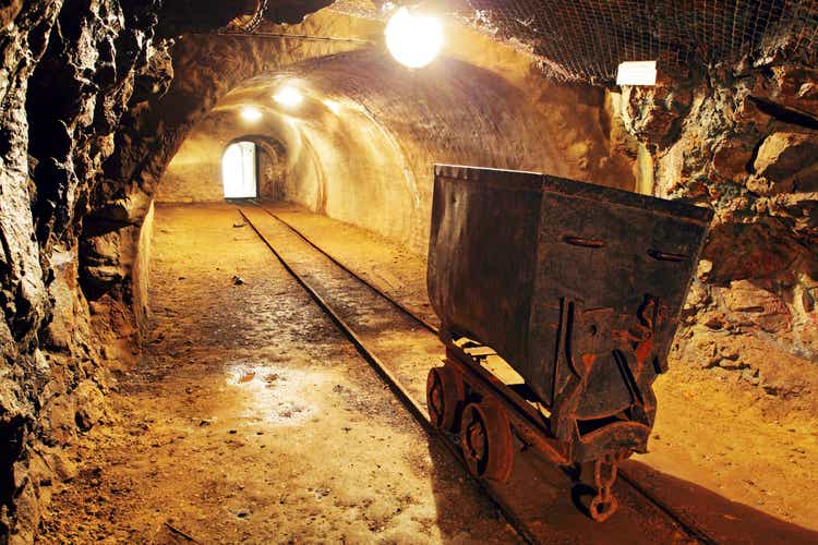 Underground train in the mine, wagons of gold, silver and copper.