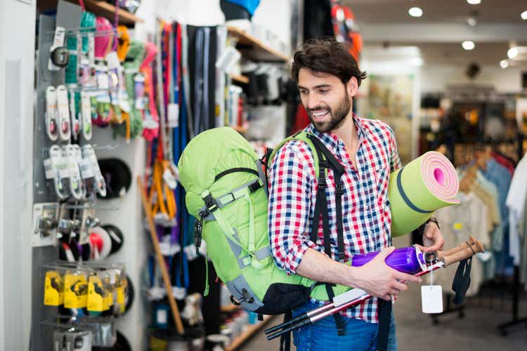 Man in the store buying camping equipment