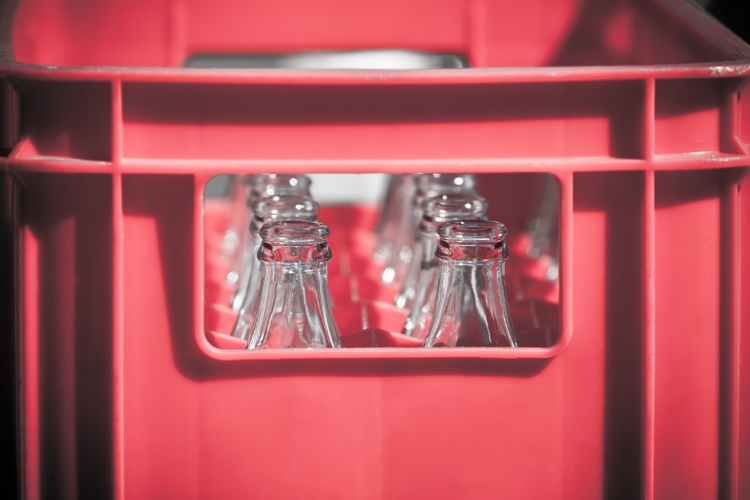 Red Plastic Crate with Empty Glass Bottles