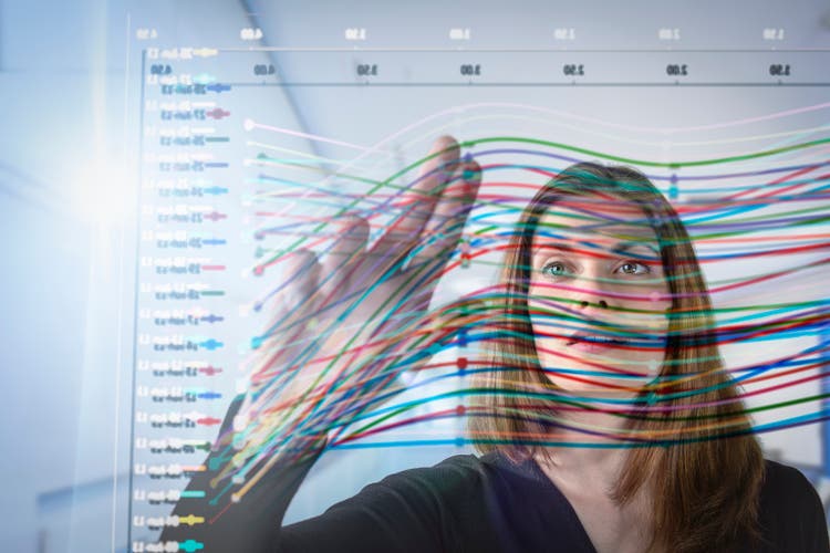 Businesswoman inspecting graph on interactive display