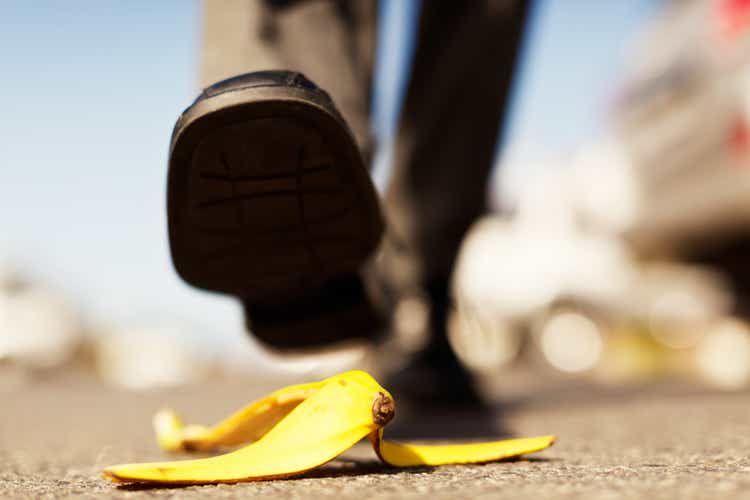 Painful accident about to happen. Foot approaching banana peel.