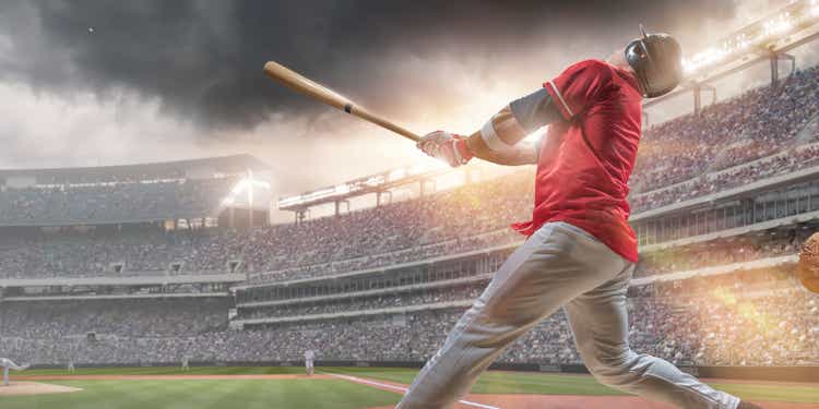 Baseball Player Hitting Ball During Baseball Game In Outdoor Stadium