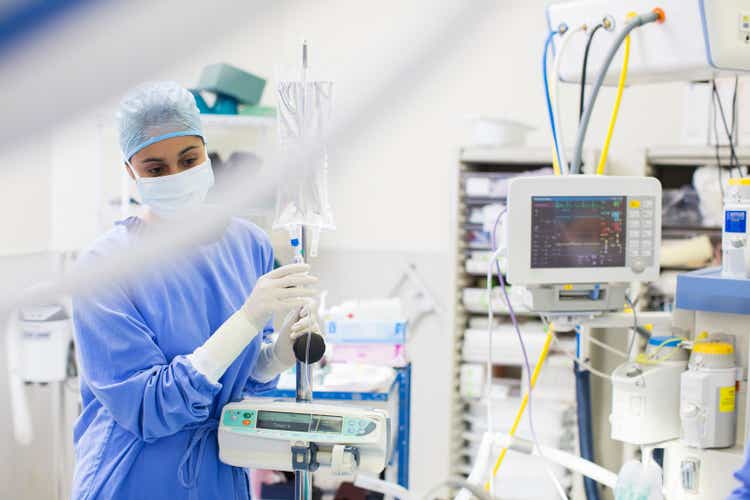 Nurse standing by medical and monitoring equipment