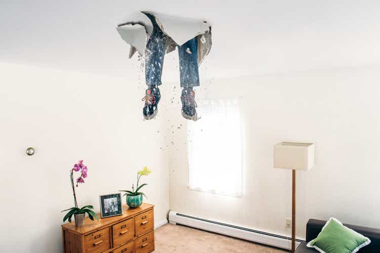 Man breaks ceiling drywall while doing DIY