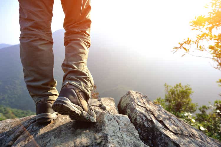 hiking feet mountain peak rock