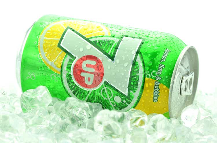 Can of 7 Up drink on ice isolated on white