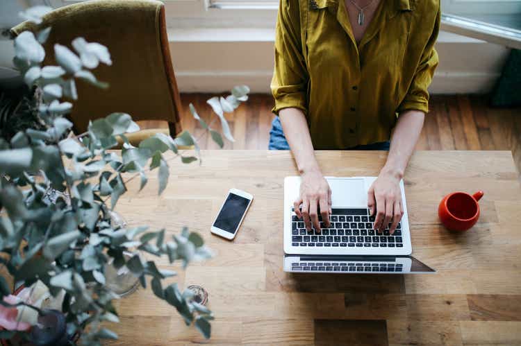 Overhead image of a female blogger writing on the laptop