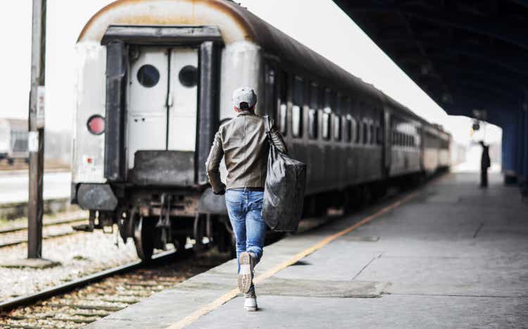 Rear view of a man catching the train.