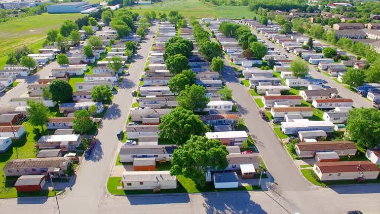 Vast trailer park, mobile home court on sunny summer morning.