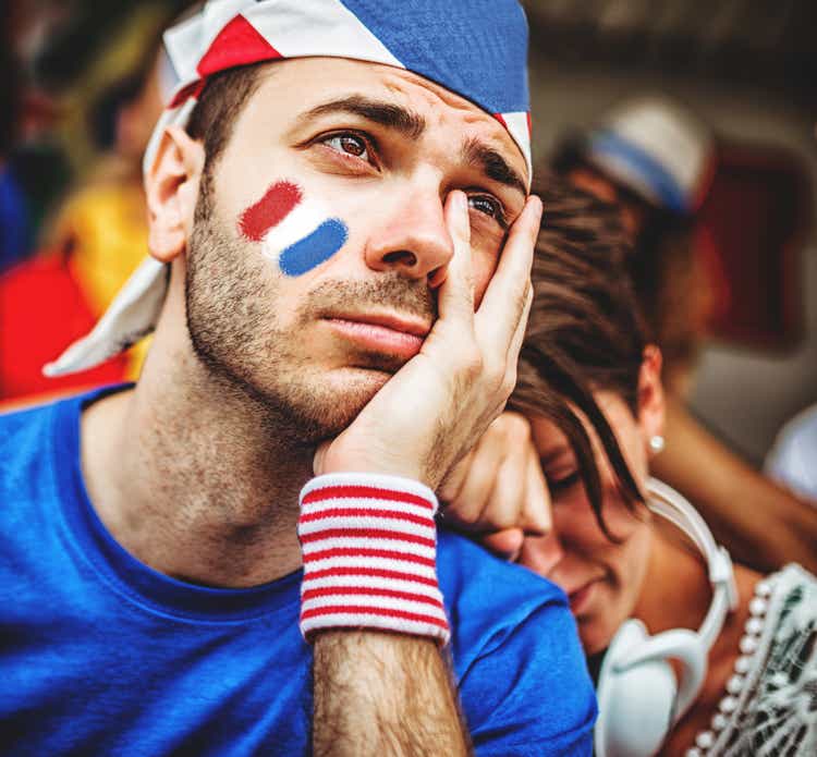 sad french supporters at stadium cheering