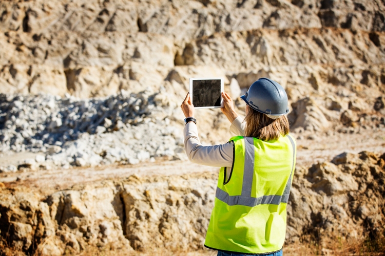 Female architect photographing quarry
