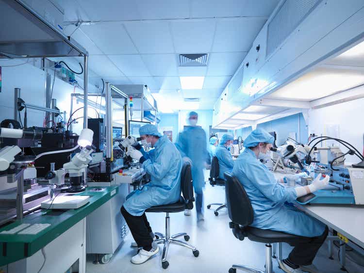 Electronics workers in clean room laboratory